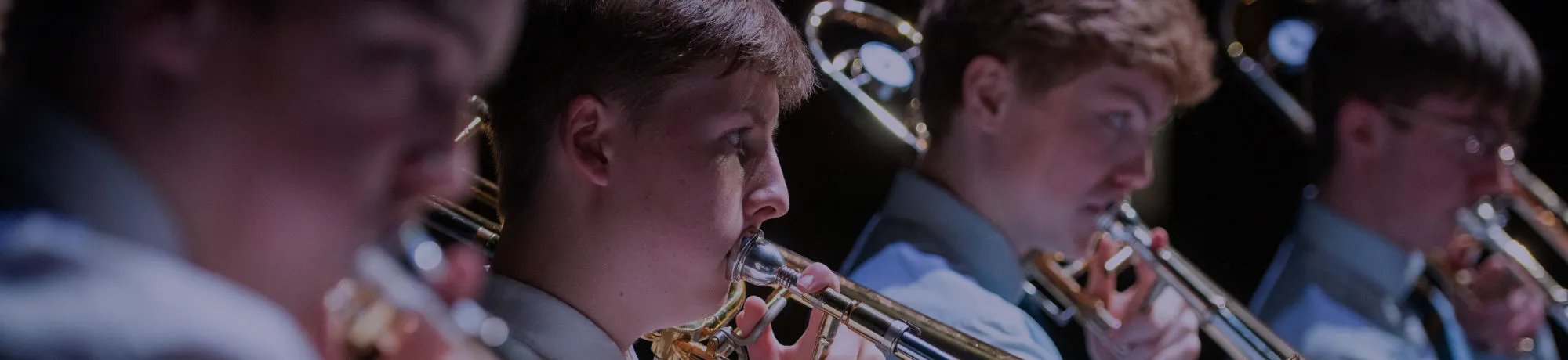 One of our concerts, in which a boy can be seen playing the trumpet and a boy in the background playing the trombone